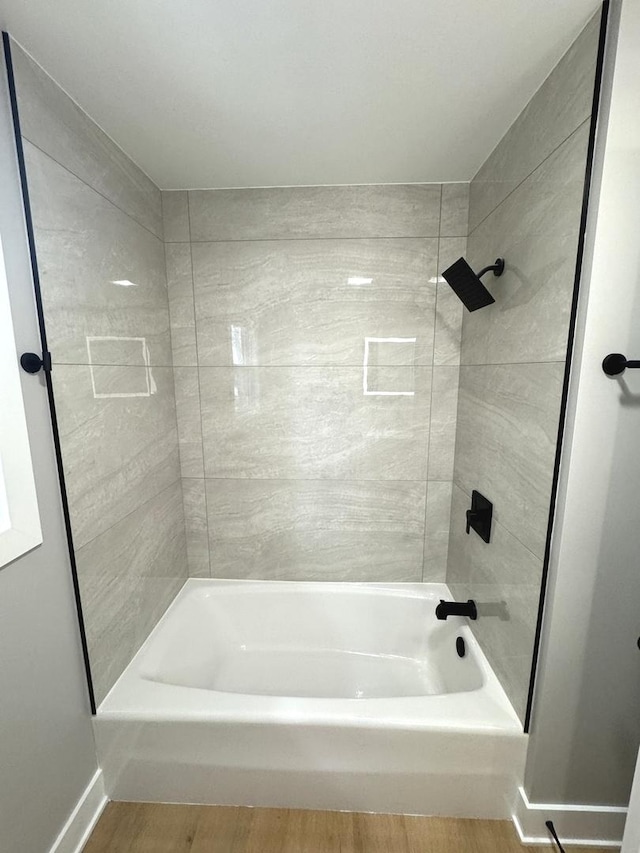 bathroom with shower / bathing tub combination and wood-type flooring