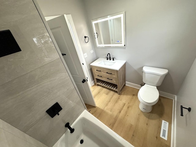 full bathroom with vanity, toilet, wood-type flooring, and shower / washtub combination