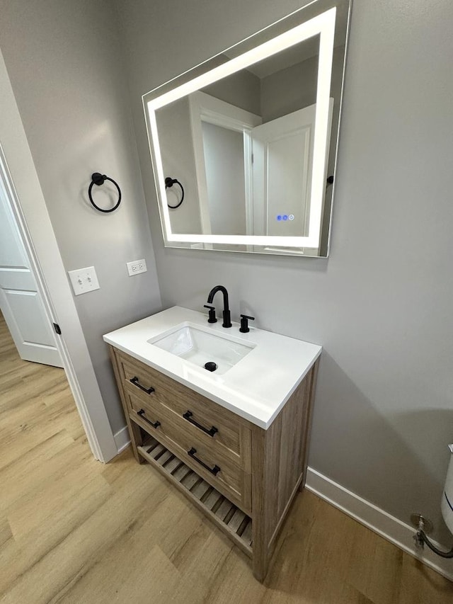 bathroom featuring hardwood / wood-style floors and vanity