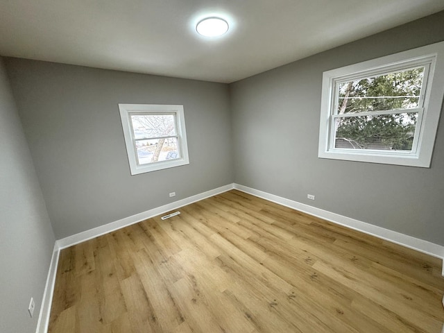 spare room featuring light hardwood / wood-style flooring