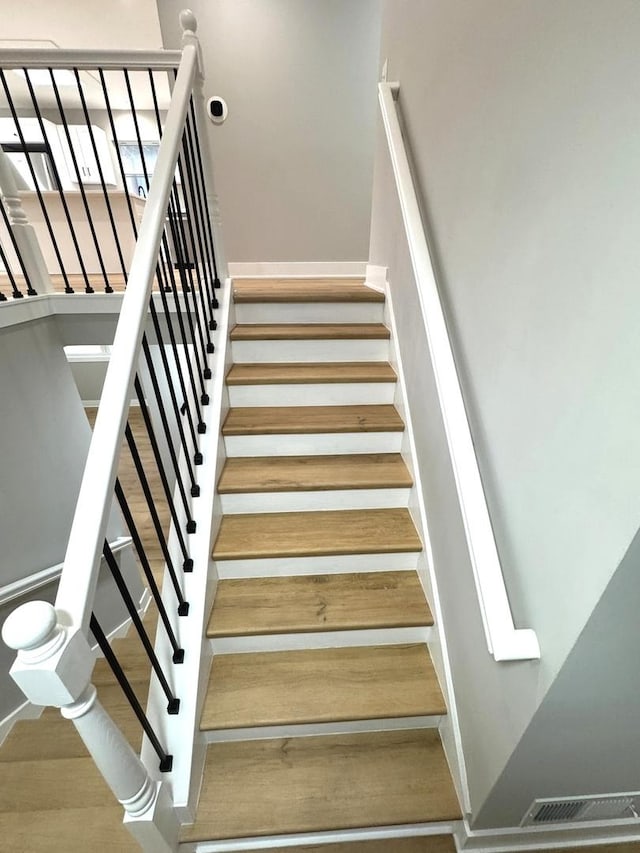 stairs featuring hardwood / wood-style flooring