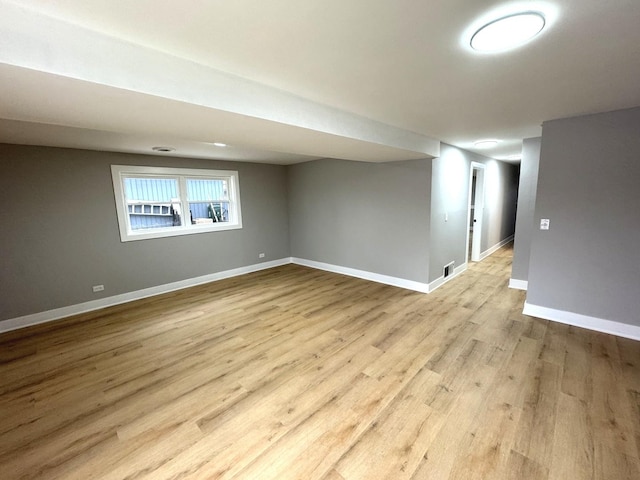 basement with light hardwood / wood-style floors