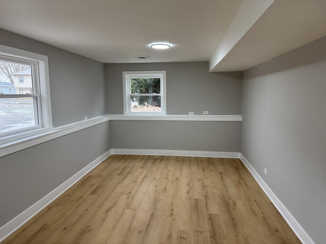 unfurnished room with light wood-type flooring