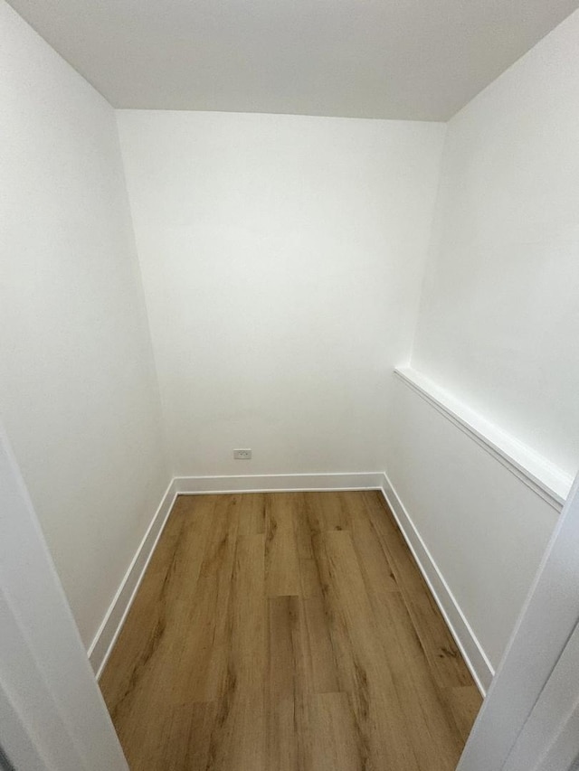 walk in closet with wood-type flooring