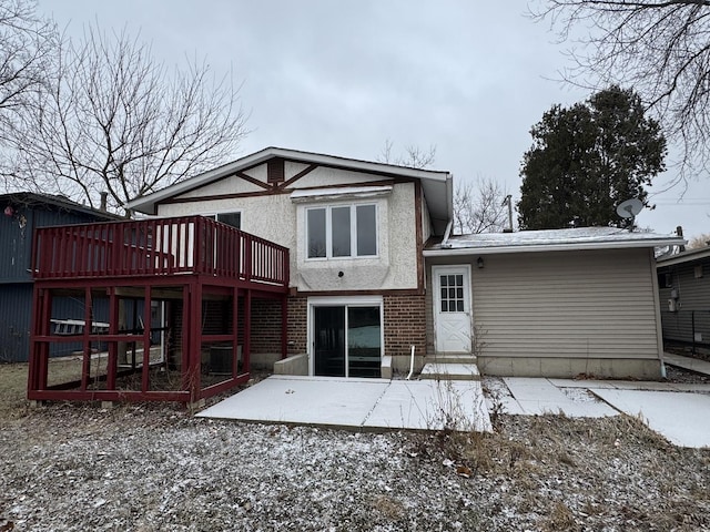 back of property featuring a deck