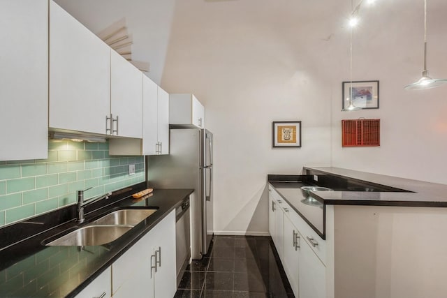 kitchen with white cabinetry, hanging light fixtures, and sink