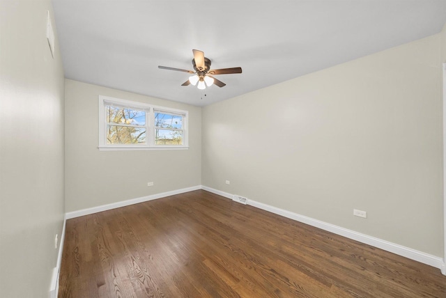 empty room with ceiling fan and dark wood-type flooring