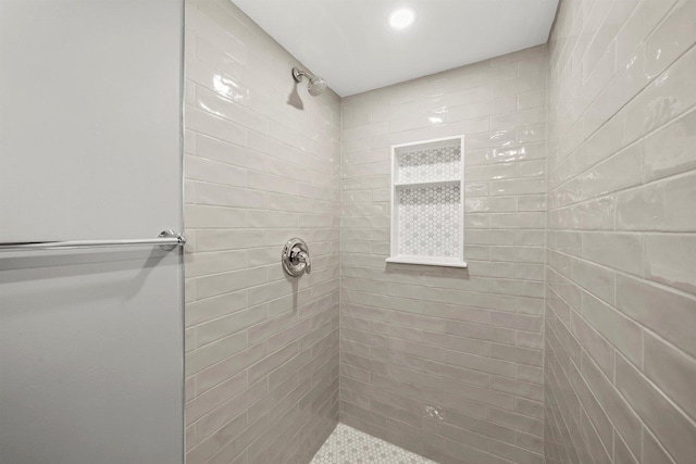 bathroom with tiled shower