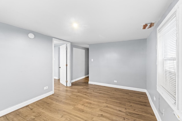 unfurnished room with light hardwood / wood-style flooring