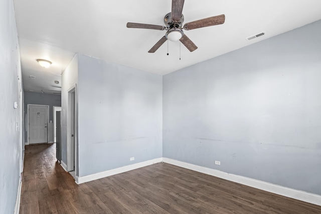 unfurnished room with ceiling fan and dark wood-type flooring