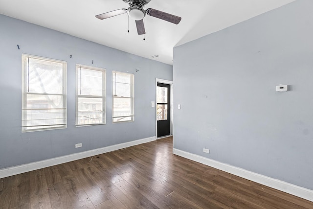 unfurnished room with dark hardwood / wood-style floors and ceiling fan