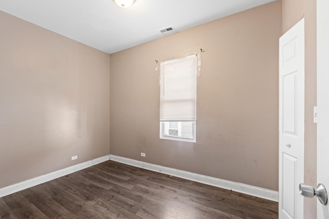 unfurnished room with dark hardwood / wood-style floors