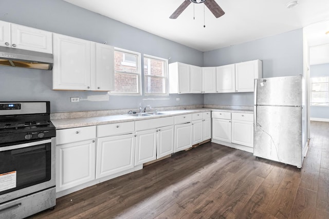 kitchen featuring white cabinetry, sink, ceiling fan, dark hardwood / wood-style flooring, and appliances with stainless steel finishes