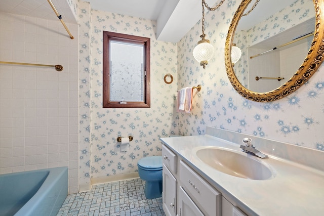 full bathroom featuring tile patterned flooring, vanity, toilet, and tiled shower / bath