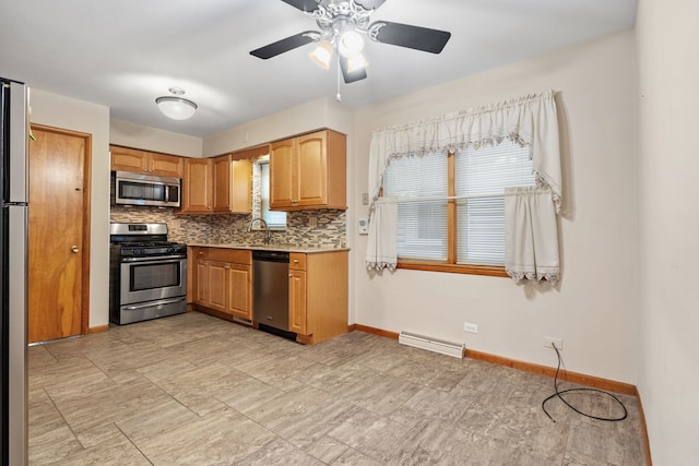 kitchen featuring backsplash, a wealth of natural light, ceiling fan, and stainless steel appliances