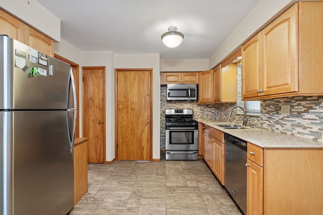 kitchen featuring light brown cabinets, sink, appliances with stainless steel finishes, and tasteful backsplash