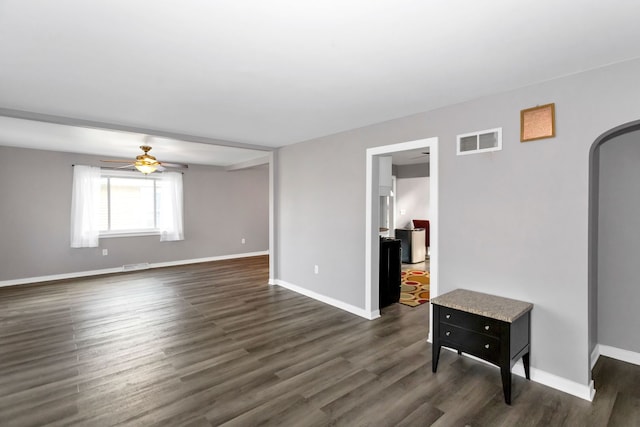 interior space featuring ceiling fan and dark hardwood / wood-style floors