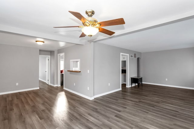 unfurnished living room with ceiling fan, beam ceiling, and dark wood-type flooring