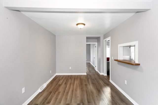 empty room featuring dark wood-type flooring