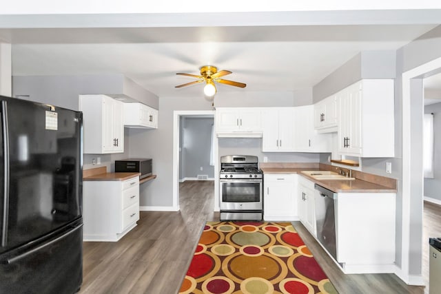 kitchen with white cabinets, appliances with stainless steel finishes, ceiling fan, and sink