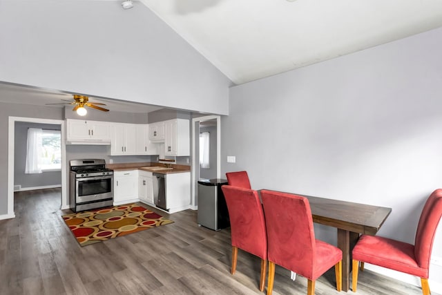 kitchen featuring ceiling fan, sink, stainless steel appliances, vaulted ceiling, and white cabinets