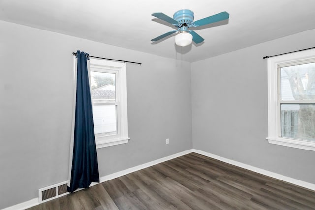 spare room featuring ceiling fan and dark wood-type flooring