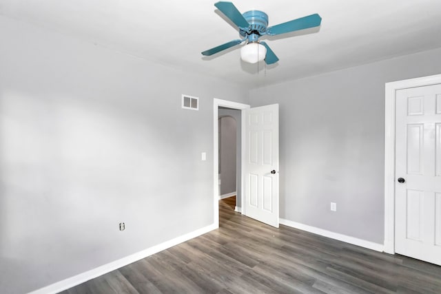 unfurnished bedroom with ceiling fan and dark hardwood / wood-style floors