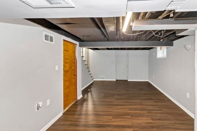 basement featuring dark hardwood / wood-style floors