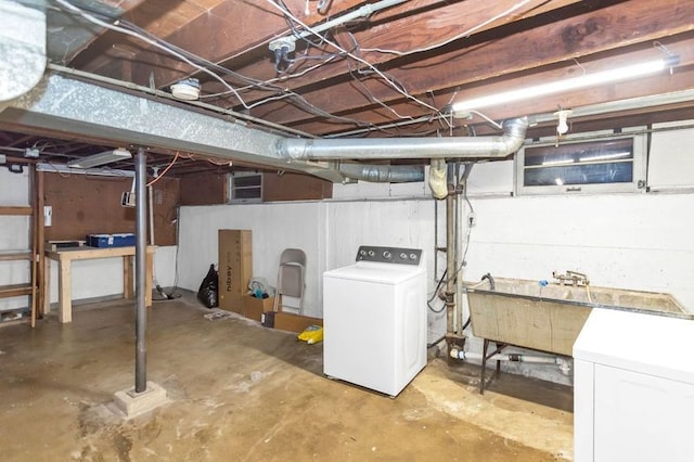 basement featuring washer / dryer and sink