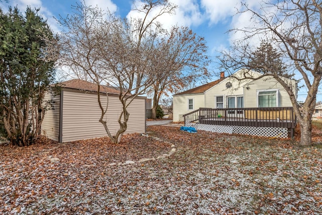 rear view of property with a wooden deck