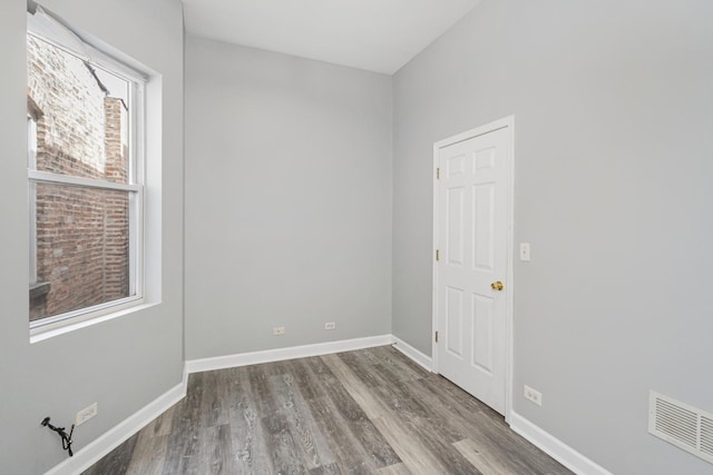 unfurnished room with wood-type flooring