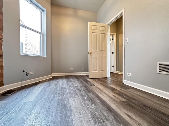 spare room with dark hardwood / wood-style floors