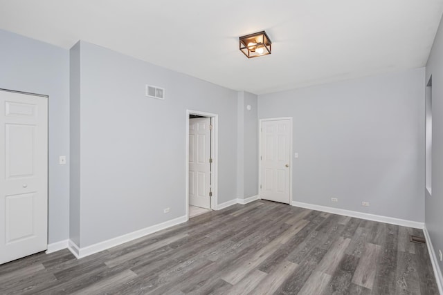 unfurnished room with wood-type flooring