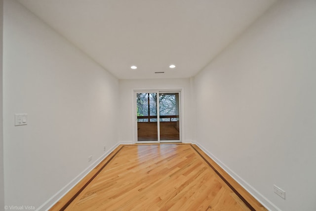 spare room with wood-type flooring