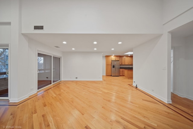 unfurnished living room featuring light wood-type flooring