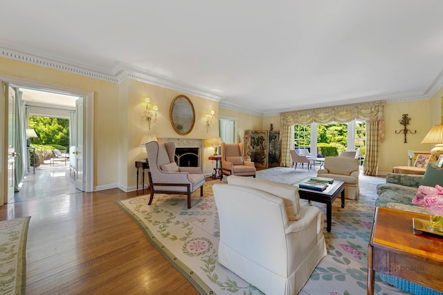 living room with crown molding and light hardwood / wood-style flooring