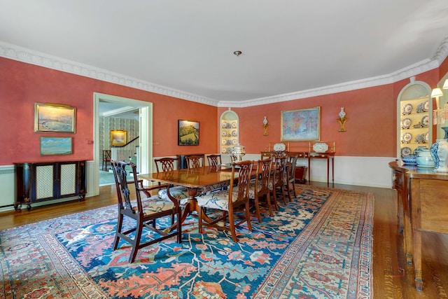 dining area with hardwood / wood-style flooring and ornamental molding