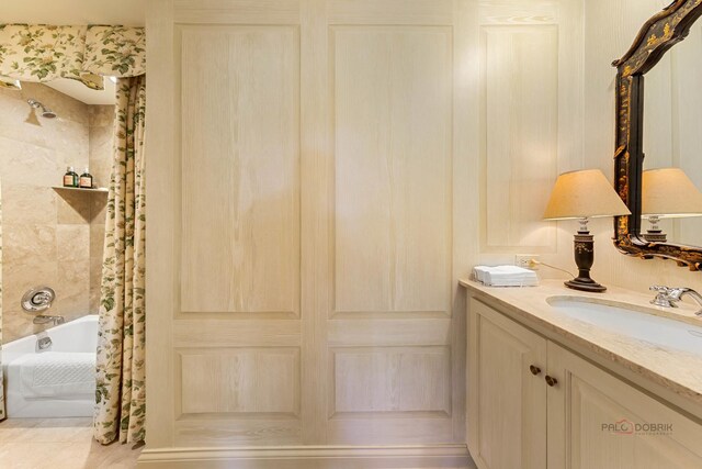 bathroom with shower / tub combo and vanity