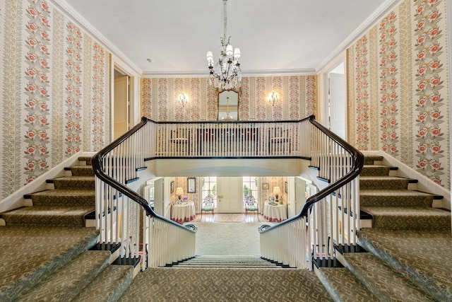 stairway with a high ceiling, crown molding, and a chandelier