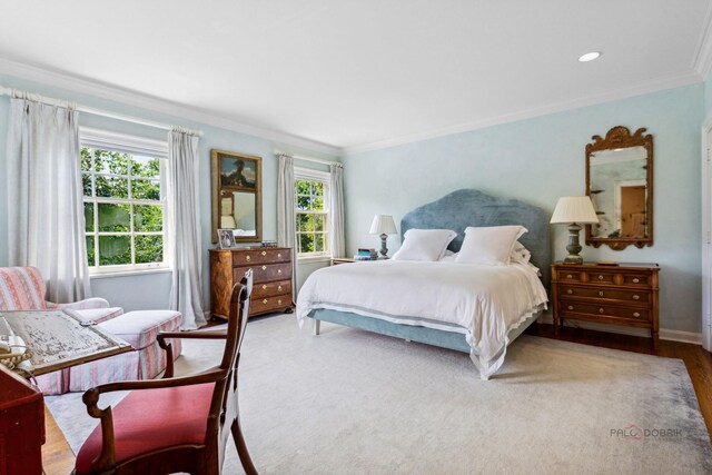 bedroom featuring crown molding and multiple windows