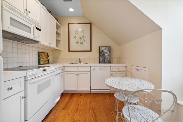 kitchen featuring sink, white appliances, white cabinetry, tasteful backsplash, and light hardwood / wood-style floors