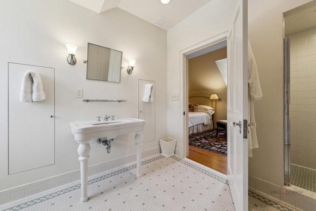 bathroom featuring lofted ceiling and an enclosed shower