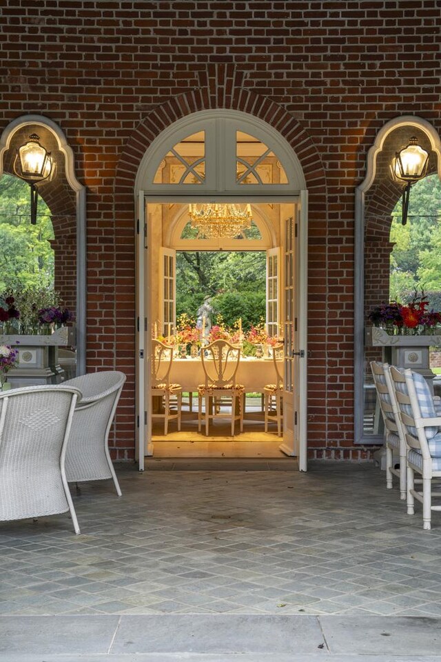 view of exterior entry featuring a patio area