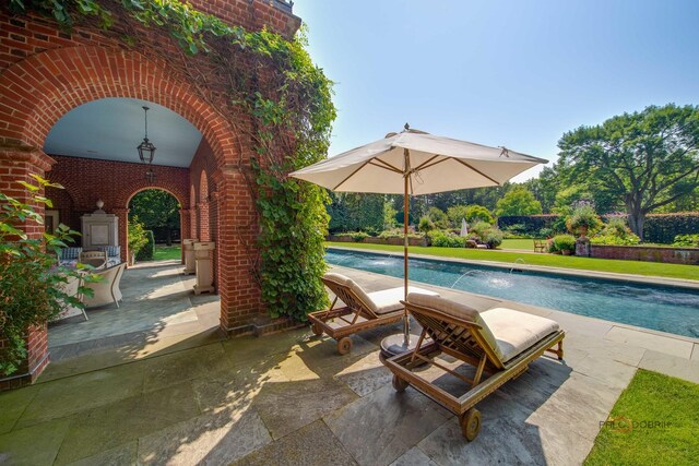 view of pool featuring pool water feature and a patio area