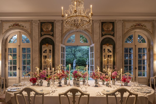 dining area featuring french doors and an inviting chandelier