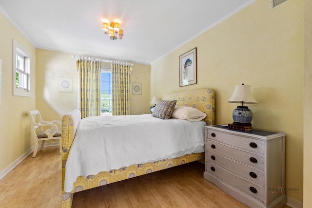 bedroom with wood-type flooring and ornamental molding