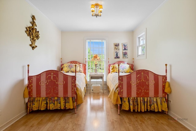 bedroom with hardwood / wood-style floors and crown molding