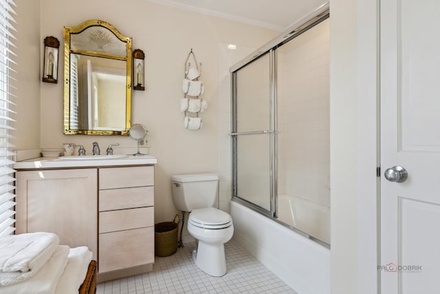 full bathroom with crown molding, combined bath / shower with glass door, vanity, tile patterned floors, and toilet