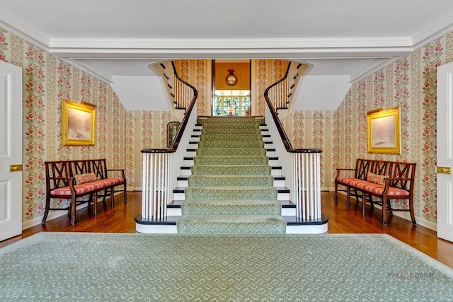 stairway with hardwood / wood-style flooring and ornamental molding