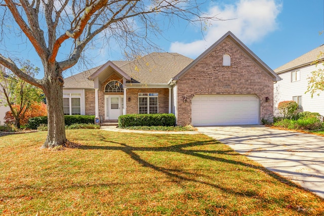 view of front facade with a garage and a front yard